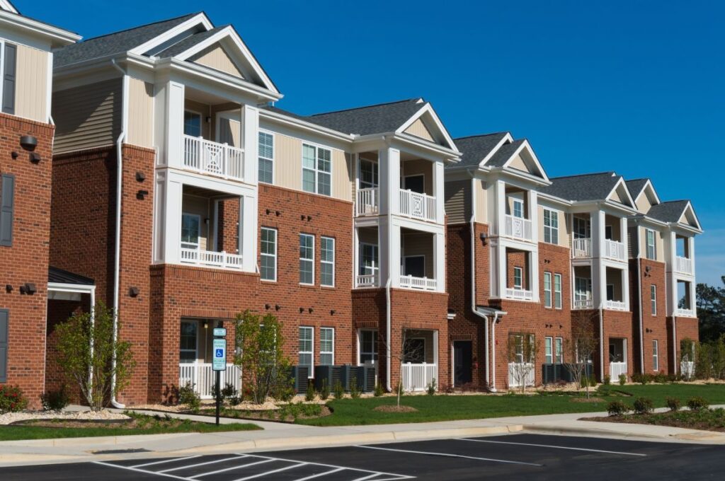 cream siding and orange brick wall complex building