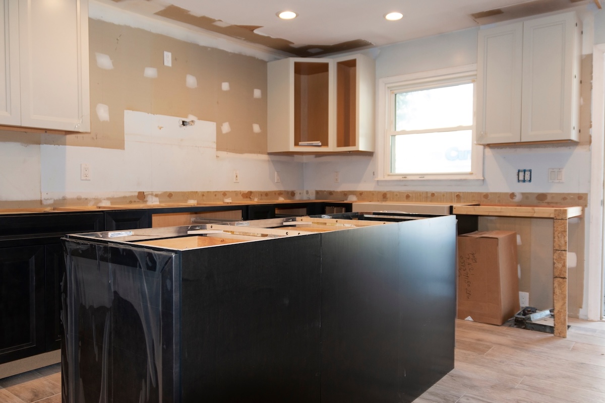 Kitchen under renovation with new cabinets, counter and a center island being constructed.