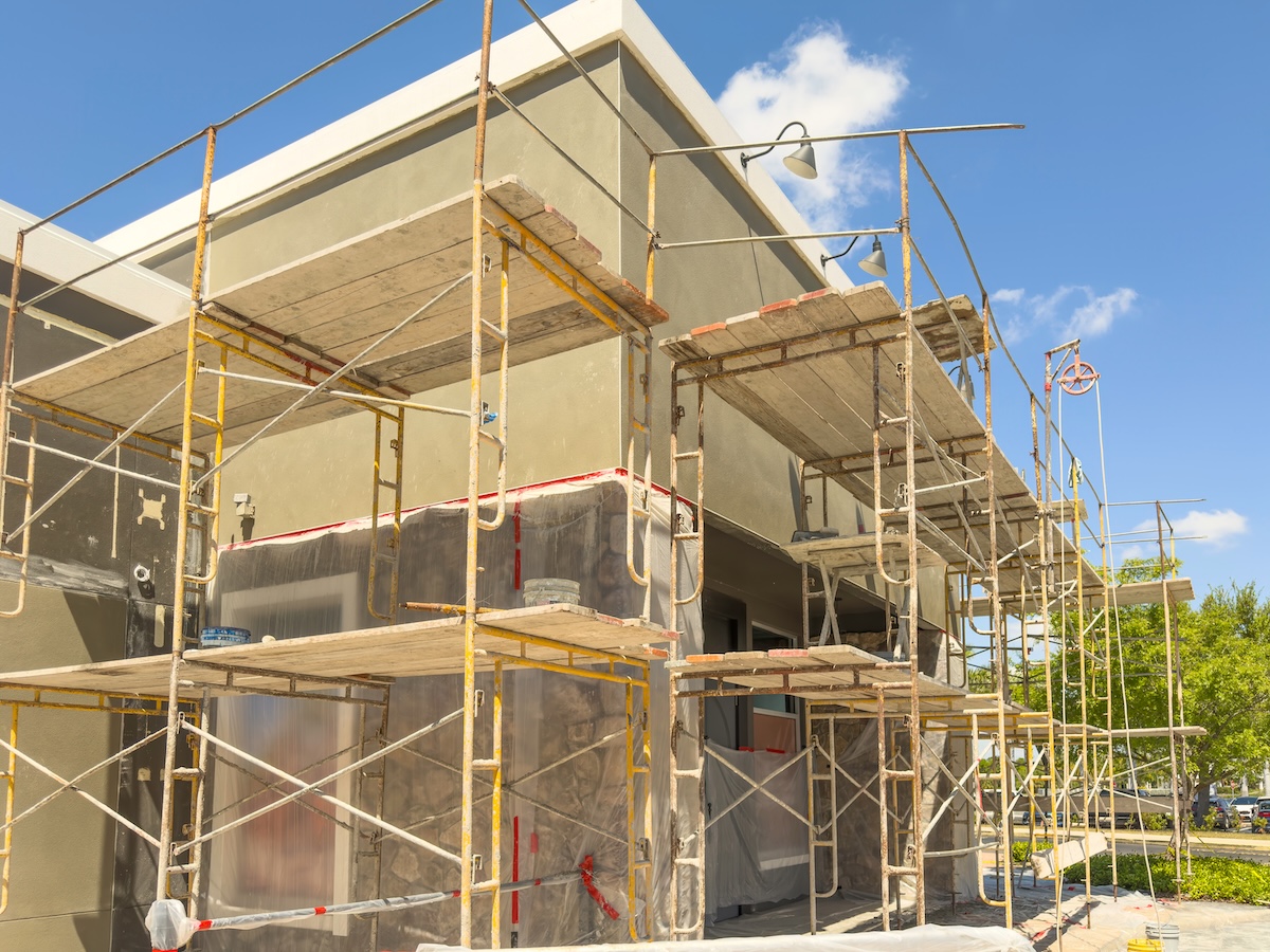 Modular scaffolding for exterior work on renovation of the facade of a defunct restaurant